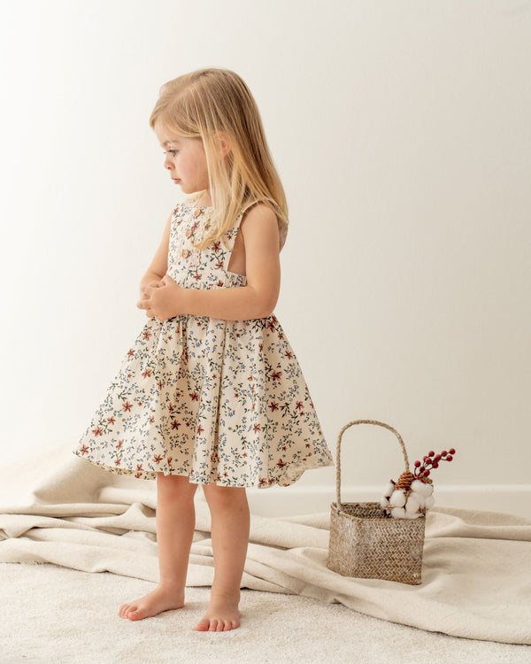 Baby girl dressing Organicline floral pinafore dress. Made from 100% certified organic cotton. 